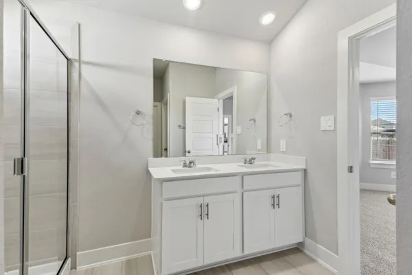 a bathroom with a double vanity sink and mirror