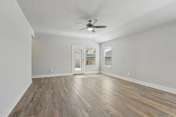 wooden floor in an empty room with a window