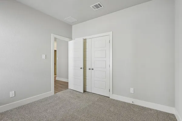 an empty room with closet area