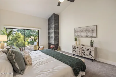 a spacious bedroom with a bed a couch and a window