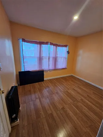 a view of wooden floor and windows in a room