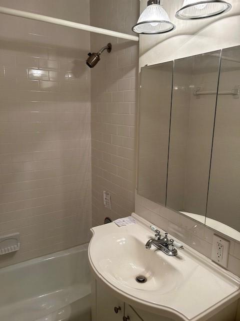a bathroom with a sink a shower and a mirror