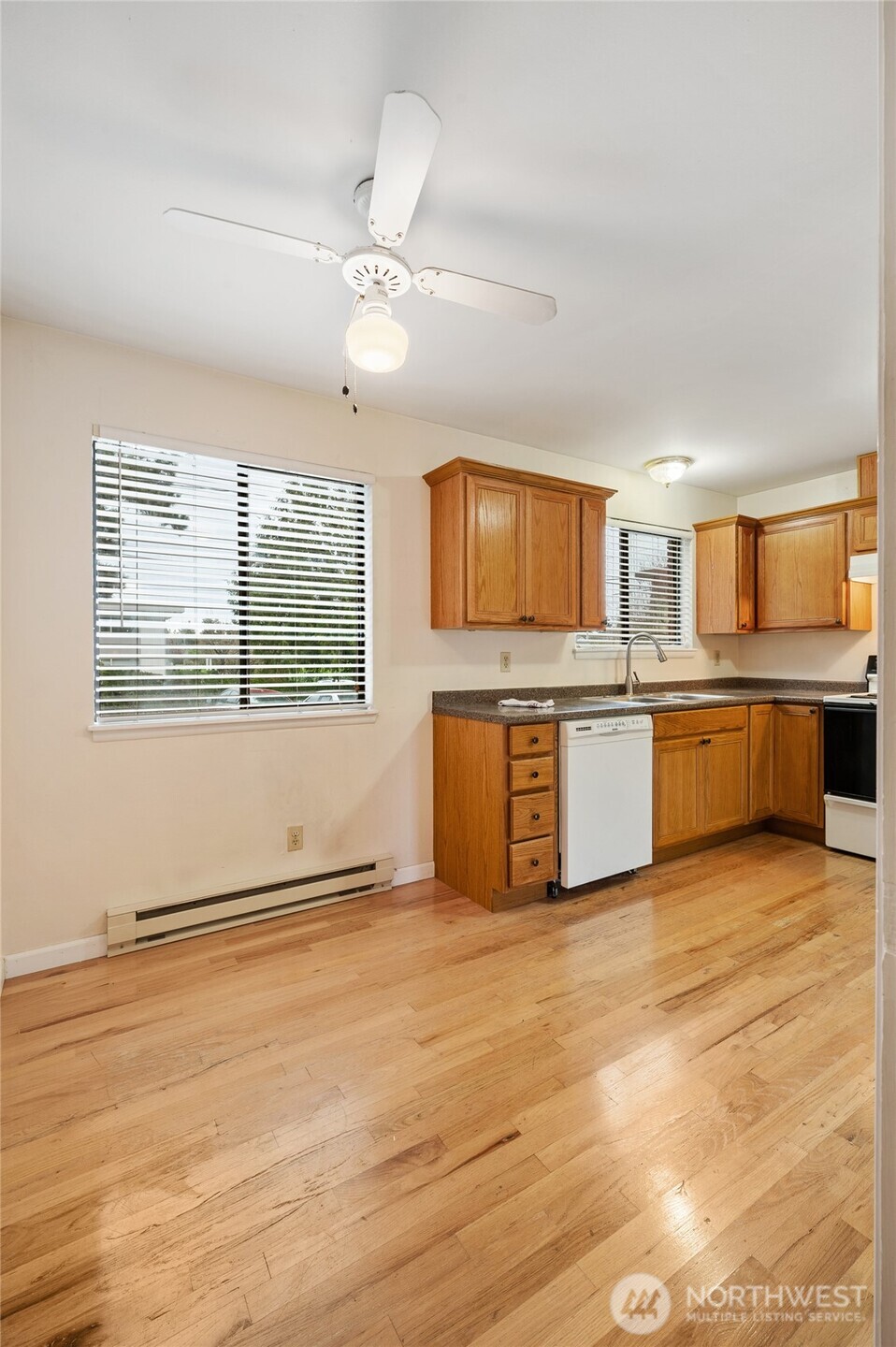 2014 Southwest 152nd Street Burien, WA 98166 - Photo 15 of 21 a view of kitchen with microwave a stove top oven and cabinets