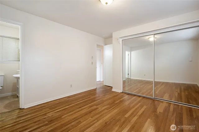 a view of an empty room and wooden floor