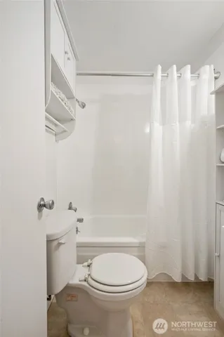 a white toilet sitting next to a bathroom sink