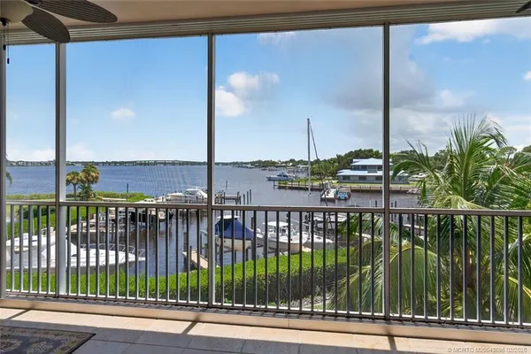 a spacious bedroom with a bed and a chandelier