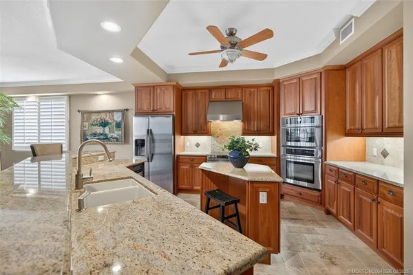 a spacious bathroom with a granite countertop sink and a mirror