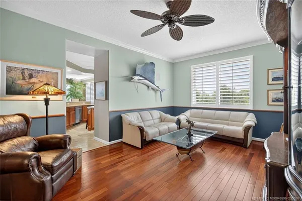 a view of a balcony with a potted plant and floor to ceiling window