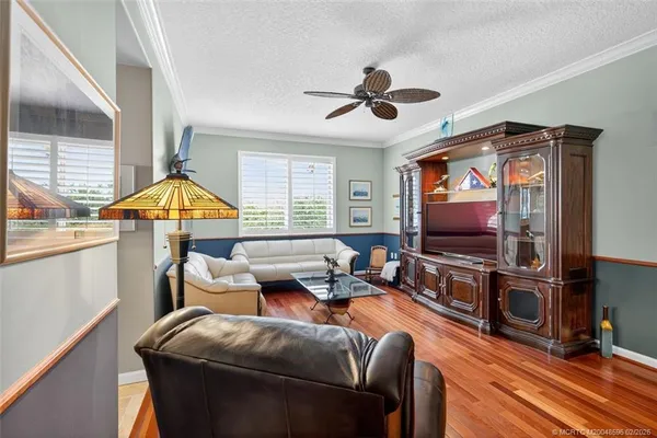 a living room with lots of furniture and a wooden floor