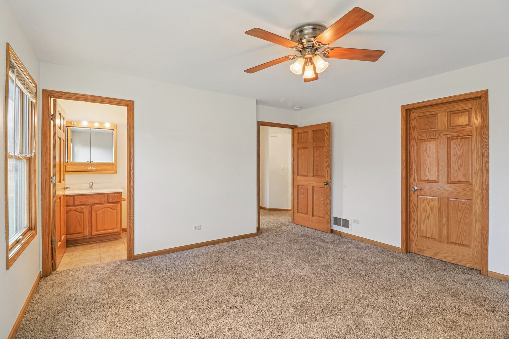 905 Randall Court Marengo, IL 60152 - Photo 15 of 28 an empty room with closet and a ceiling fan