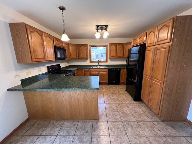 905 Randall Court Marengo, IL 60152 - Photo 7 of 28 a kitchen with granite countertop a refrigerator a stove top oven and cabinets