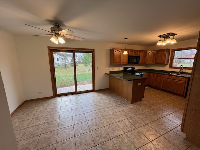 905 Randall Court Marengo, IL 60152 - Photo 10 of 28 a kitchen with a stove a sink and a refrigerator