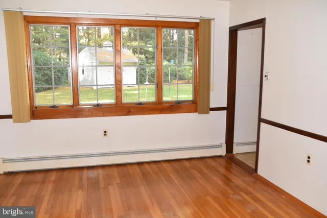 an empty room with wooden floor