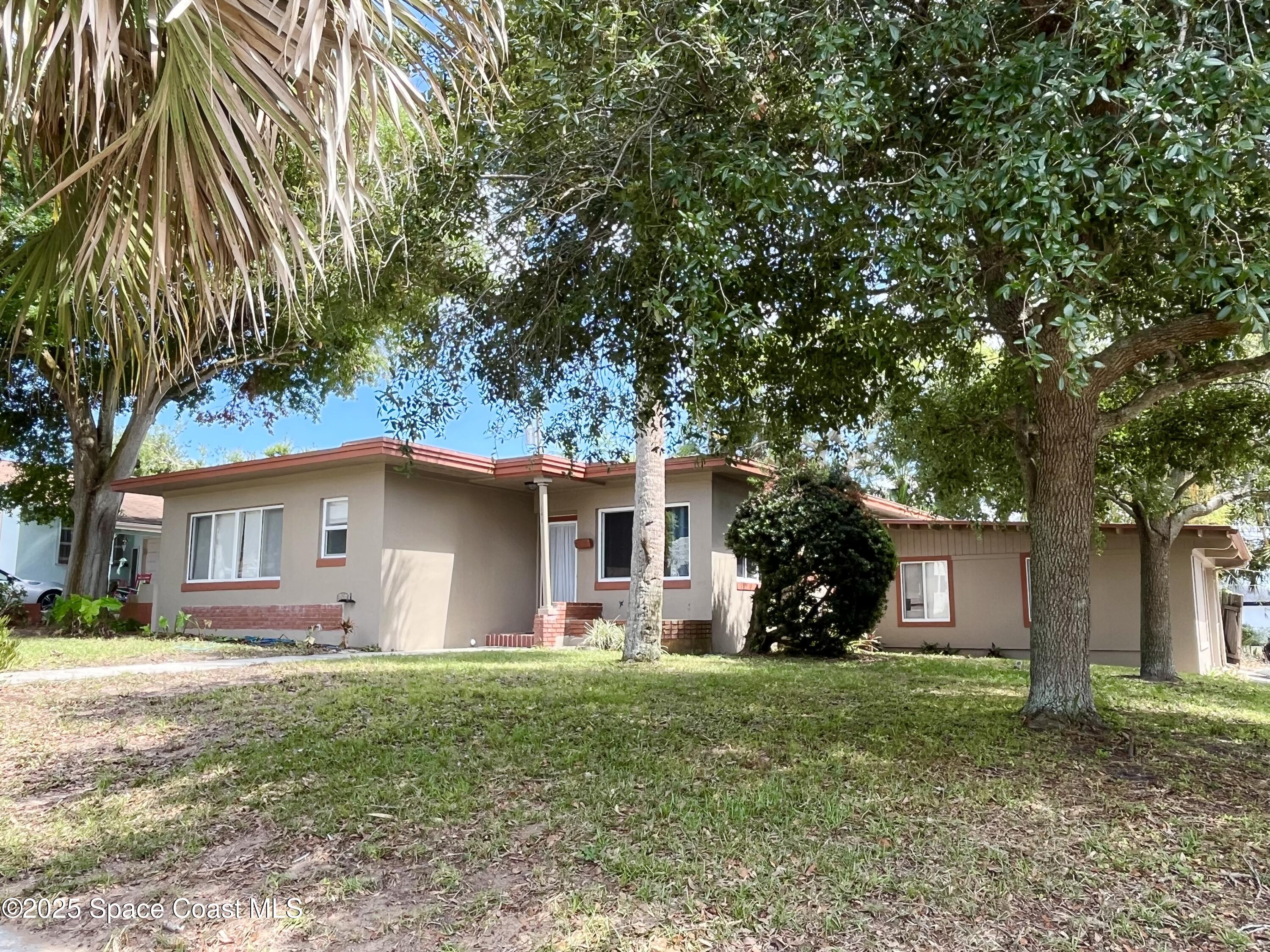 a front view of house with yard and green space