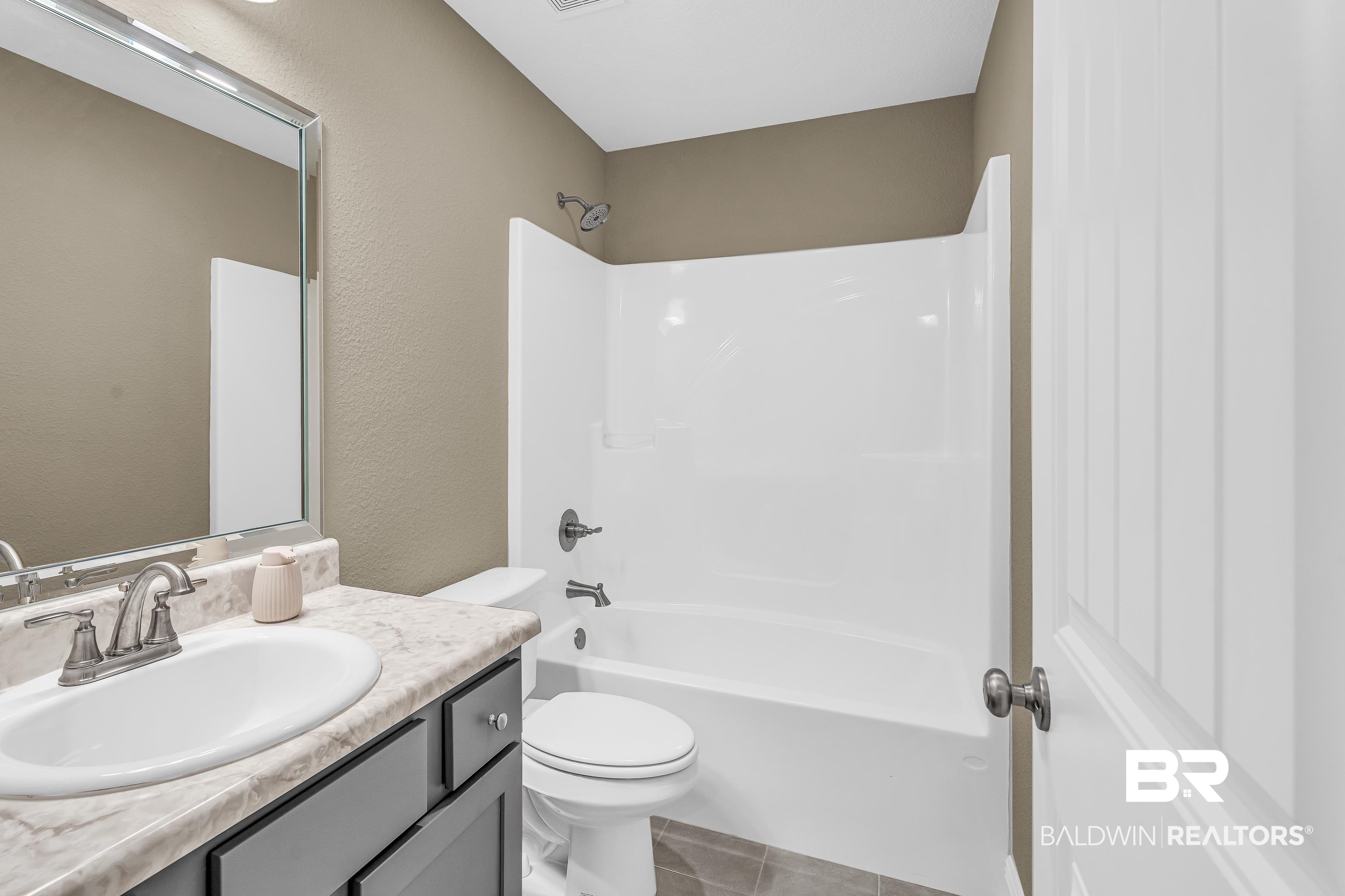 9206 Greenleaf Drive Daphne, AL 36527 - Photo 21 of 32 Bathroom with vanity, shower / bathtub combination, and light tile patterned floors