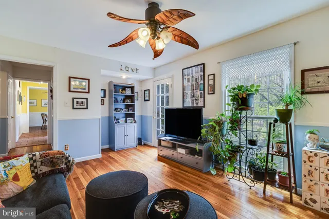 a view of a dining room with furniture wooden floor and chandelier