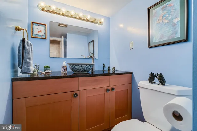a kitchen with stainless steel appliances granite countertop sink stove and white cabinets
