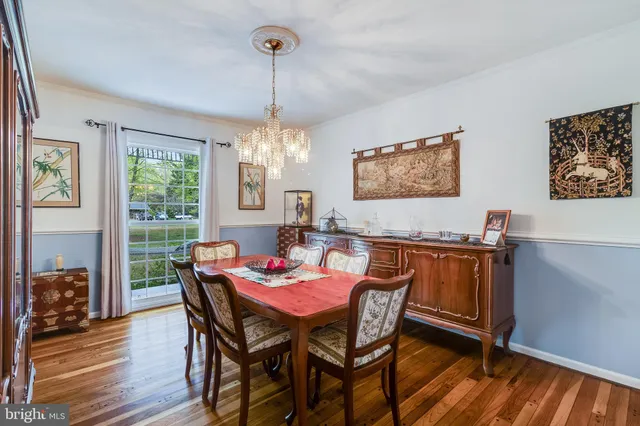 a kitchen with stainless steel appliances granite countertop a refrigerator a sink a stove and white cabinets