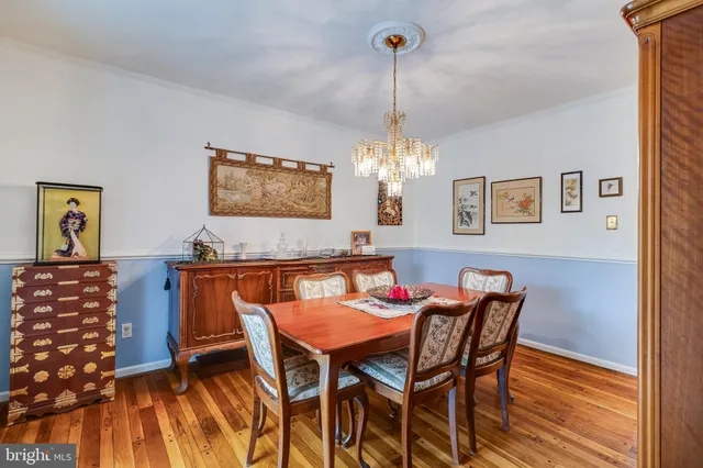 a kitchen with stainless steel appliances granite countertop a sink a stove and a wooden floors