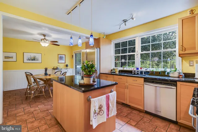 a dining room with furniture and a floor to ceiling window