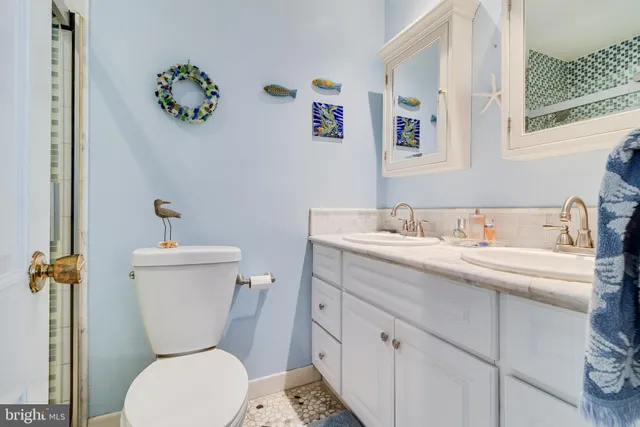 a view of a patio with table and chairs and potted plants with large trees