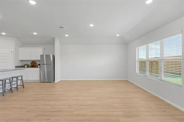 a view of kitchen with stainless steel appliances refrigerator oven and cabinets