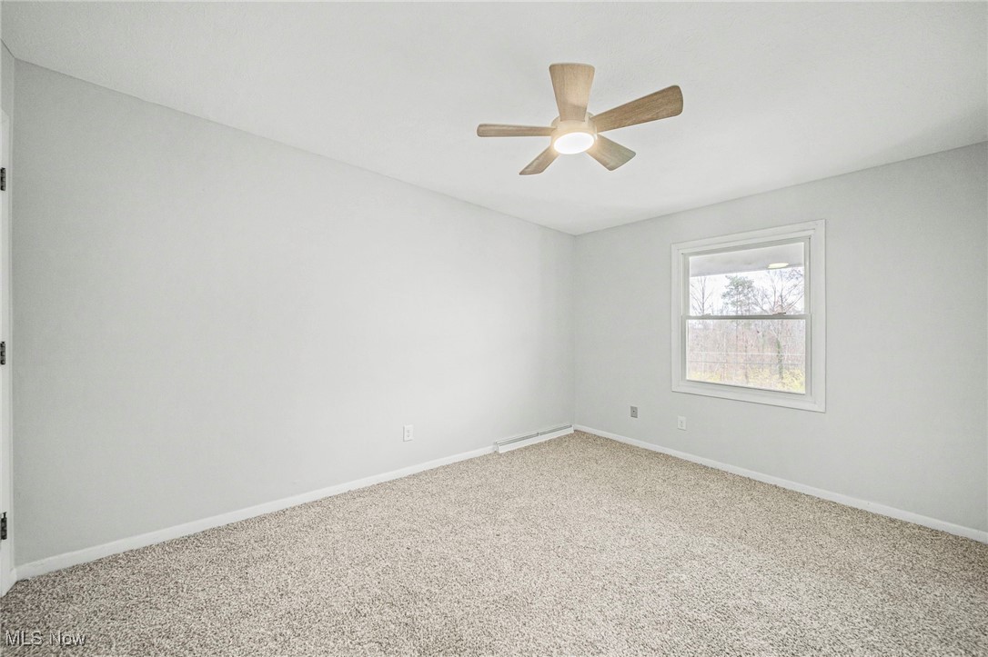 91 Paradise Road Painesville, OH 44077 - Photo 22 of 39 Empty room with carpet floors and ceiling fan