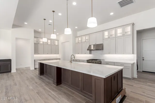 a view of kitchen with stainless steel appliances granite countertop a sink and a refrigerator