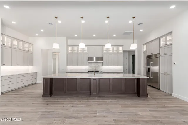 a large white kitchen with a large island in it