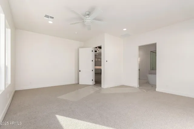 an empty room with windows and entrance