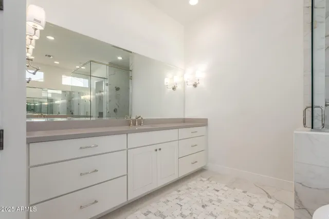 a spacious bathroom with a shower sink and mirror