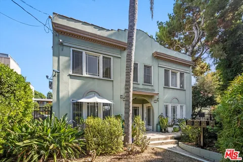 a front view of a residential houses with yard