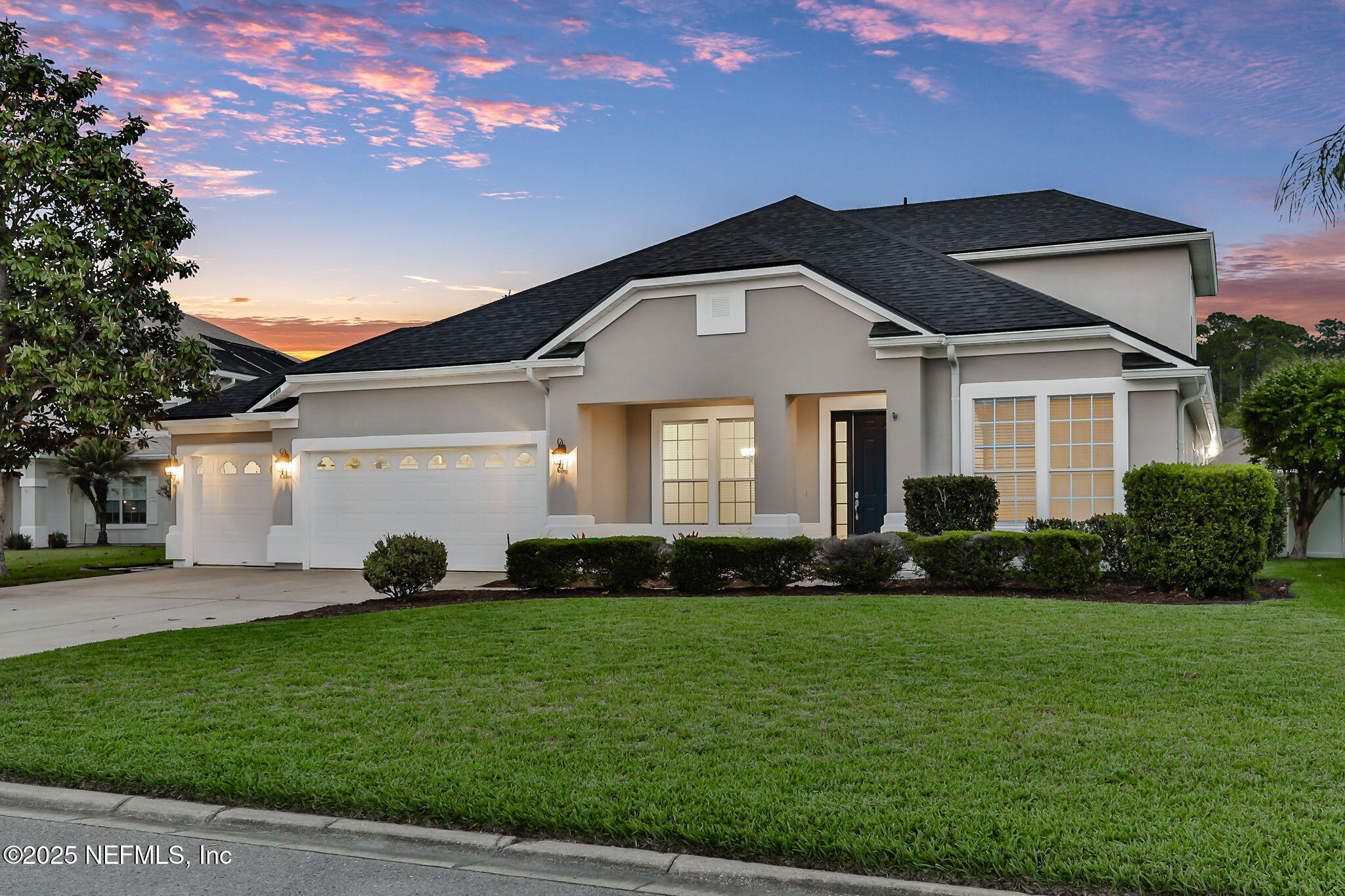 a front view of a house with a yard and garage