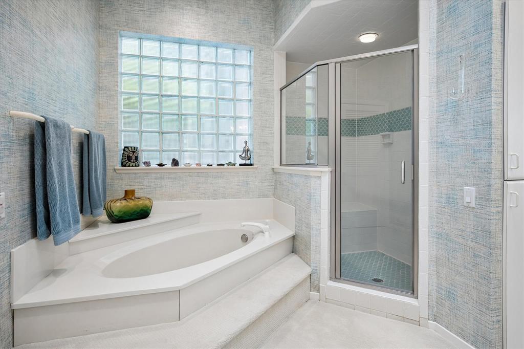 6419 Laurel Valley Road Dallas, TX 75248 - Photo 17 of 34 a bathroom with a tub and a shower