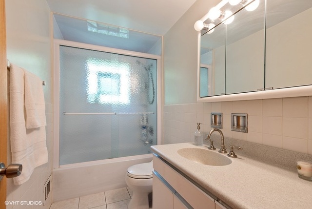 999 Shermer Road Northbrook, IL 60062 - Photo 13 of 17 a bathroom with a sink toilet vanity and shower