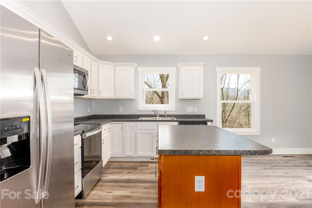 5 Sharptown Road Canton, NC 28716 - Photo 12 of 22 a kitchen with stainless steel appliances granite countertop a sink stove and refrigerator