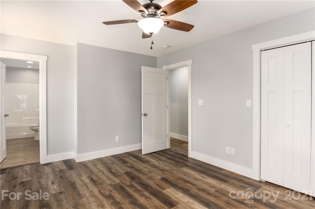 5 Sharptown Road Canton, NC 28716 - Photo 13 of 22 wooden floor in an empty room with a chandelier fan