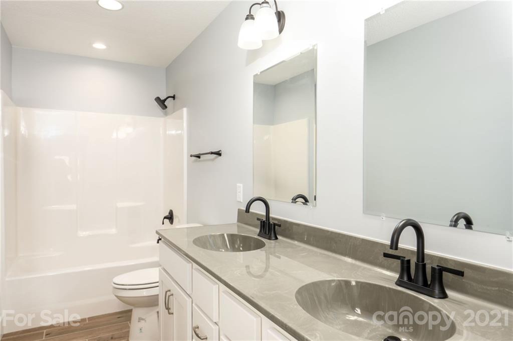 5 Sharptown Road Canton, NC 28716 - Photo 14 of 22 a bathroom with a sink and mirror with toilet