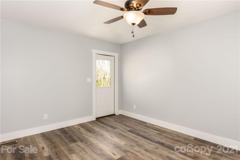 5 Sharptown Road Canton, NC 28716 - Photo 15 of 22 an empty room with a window and a fan