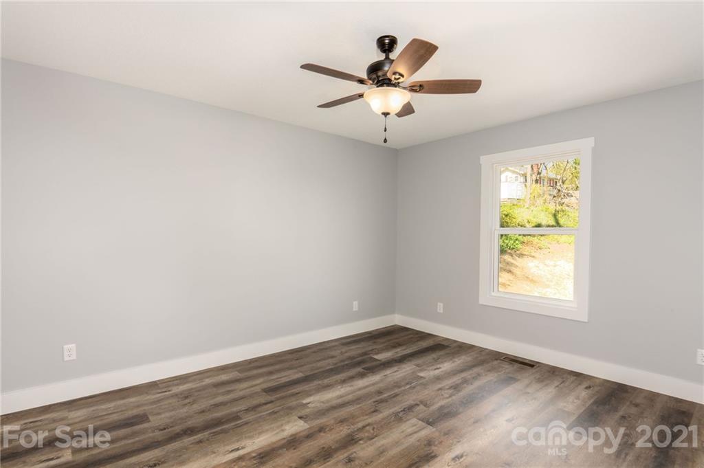5 Sharptown Road Canton, NC 28716 - Photo 17 of 22 an empty room with wooden floor and windows