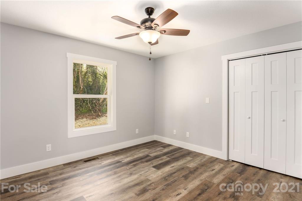 5 Sharptown Road Canton, NC 28716 - Photo 18 of 22 an empty room with windows and fan