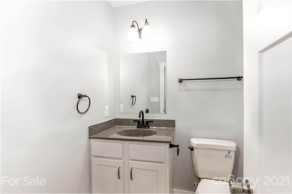 5 Sharptown Road Canton, NC 28716 - Photo 19 of 22 a bathroom with a toilet sink and mirror