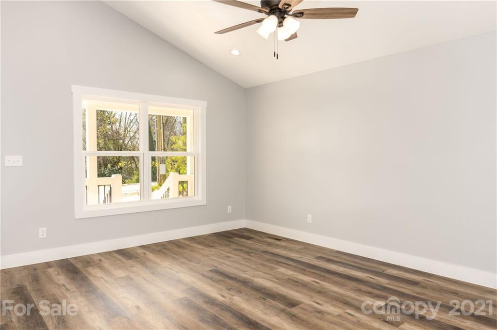 5 Sharptown Road Canton, NC 28716 - Photo 8 of 22 an empty room with a window and a fan
