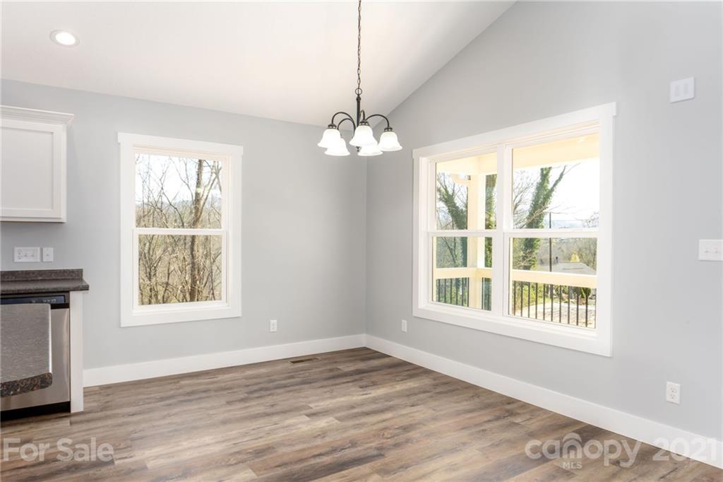 5 Sharptown Road Canton, NC 28716 - Photo 9 of 22 a view of an empty room with a window and wooden floor
