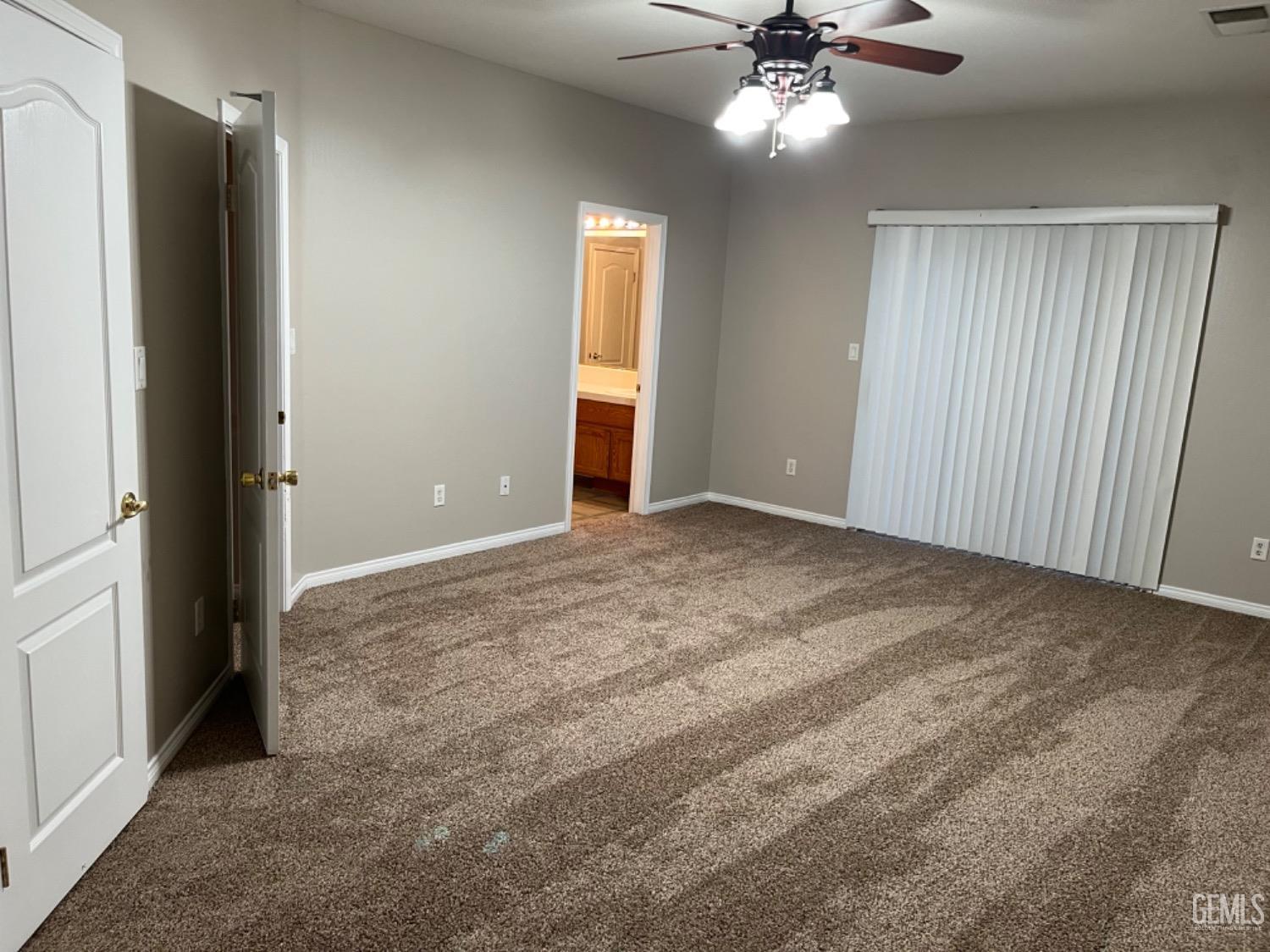 Undisclosed Address Bakersfield, CA 93311 - Photo 13 of 19 an empty room with closet and a chandelier fan