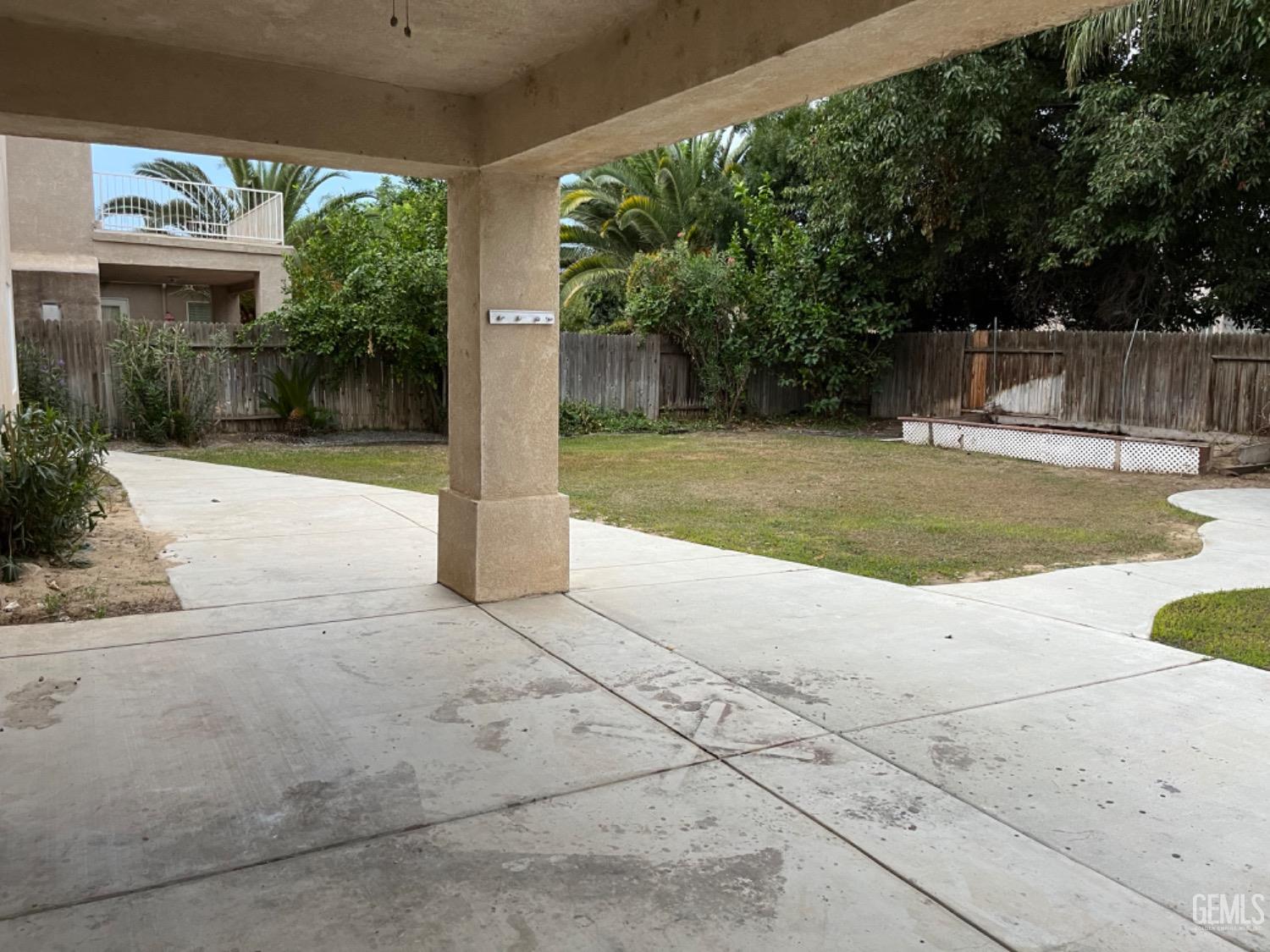 Undisclosed Address Bakersfield, CA 93311 - Photo 19 of 19 a view of a backyard with large trees and plants