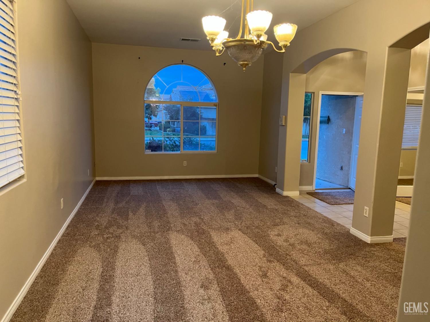 Undisclosed Address Bakersfield, CA 93311 - Photo 3 of 19 a view of a bedroom with a chandelier