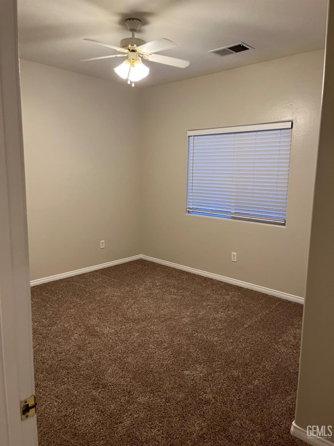 Undisclosed Address Bakersfield, CA 93311 - Photo 6 of 19 an empty room with a window and a fan