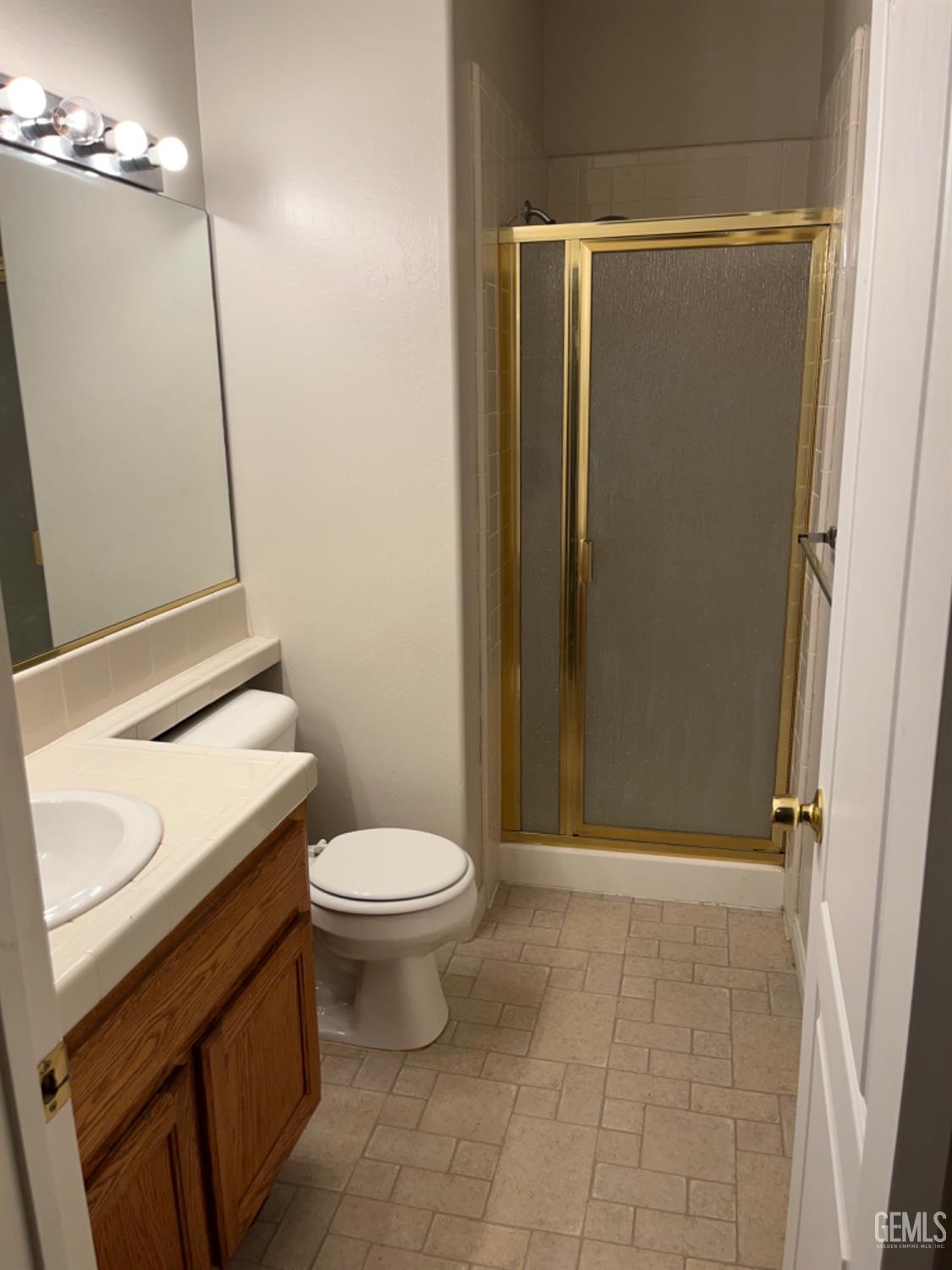 Undisclosed Address Bakersfield, CA 93311 - Photo 7 of 19 a bathroom with a sink a toilet a mirror and shower