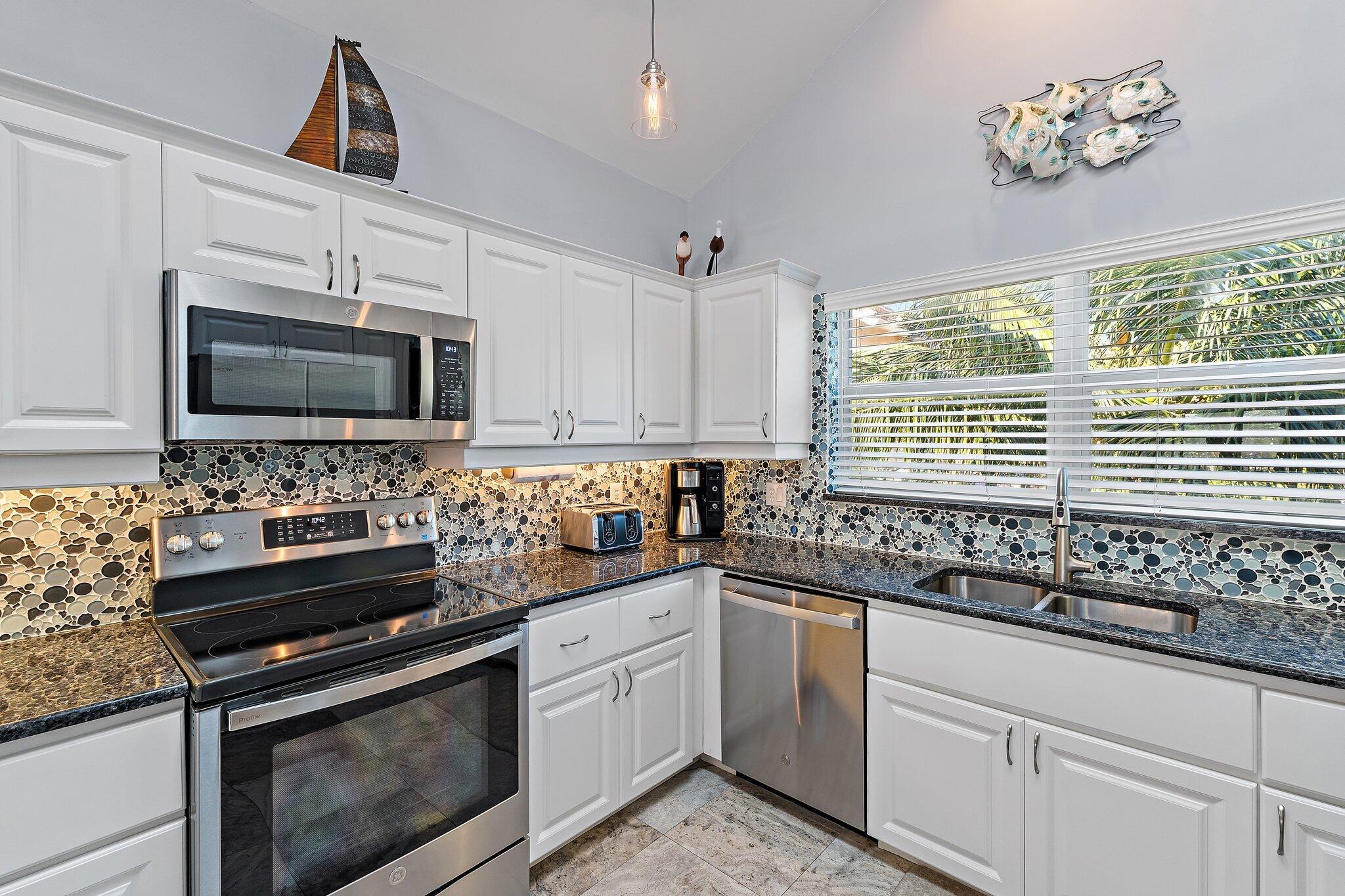 4161 U.S. Highway 1, Unit G3 Jupiter, FL 33477 - Photo 11 of 71 a kitchen with a sink stove and microwave